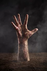 Foto op Plexiglas Human hand in blood and dirt on dark background © Nik_Merkulov