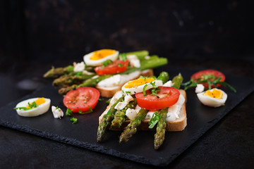 Sandwiches with caramelized asparagus, feta cheese, tomatoes and eggs.