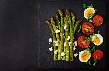 Warm salad of roasted asparagus, feta cheese, tomatoes and eggs. Top view