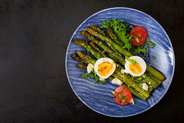 Warm salad of roasted asparagus, feta cheese, tomatoes and eggs. Top view