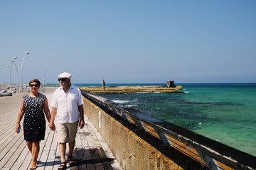 senior couple walking near the sea