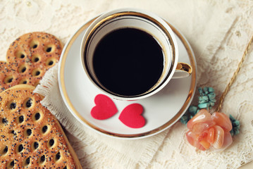 Cup of coffee and felt hearts. Top view, soft focus.