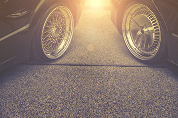 background of tuning car wheels on street - obrazy, fototapety, plakaty