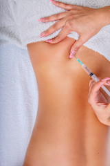 Syringe injection in to woman's back.