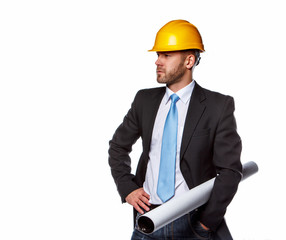 A man in a suit and safety yellow helmet.