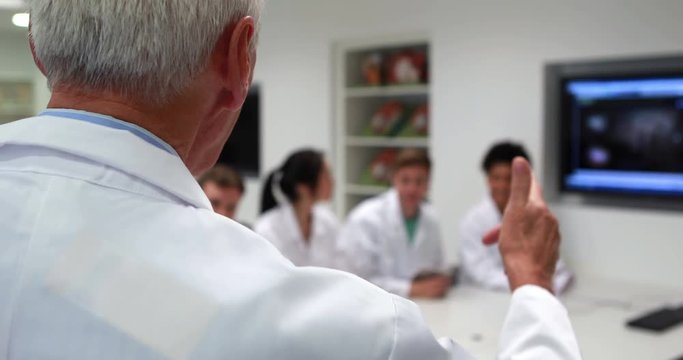 Medical professor teaching young students in high quality 4k format