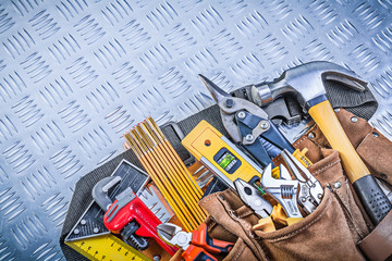 Tool belt with construction objects on corrugated metal pattern 