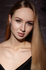 Fototapeta na wymiar Beautiful young woman with clean skin, shiny blond straight hair, fashion makeup. Glamour make-up, perfect shape eyebrows. Portrait sexy blonde. Evening elegant style