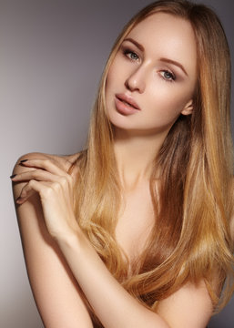 Beautiful young woman with clean skin, beautiful straight shiny hair, fashion makeup. Glamour make-up, perfect shape eyebrows. Portrait sexy blondy. Beautiful smooth hairstyle. Shiny nail polish

