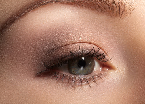 Close-up macro of beautiful female eye with perfect shape eyebrows. Clean skin, fashion naturel make-up. Good vision

