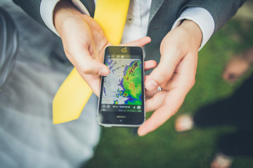 Detecting the weather forecast with rain radar on mobile phone - obrazy, fototapety, plakaty