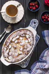 Clafoutis with cherries and powdered sugar for breakfast  