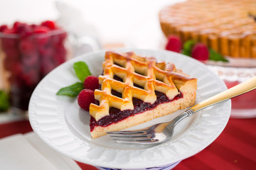 Homemade slice of golden brown berry raspberry tart pie on plate sweet treat