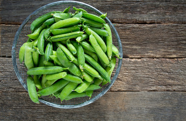 pea pods on wooden surface