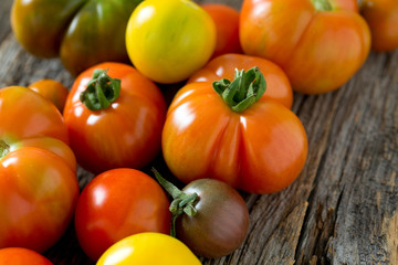 colorful organic tomatoes on wooden surface