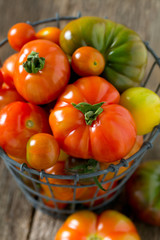 colorful organic tomatoes on wooden surface