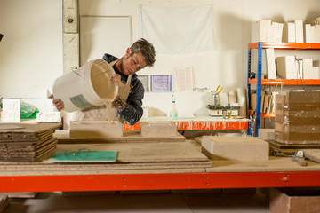 Man Pouring Gypsum Mixture onto Mold