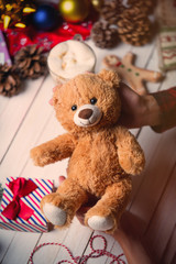 female hand holding a teddy bear