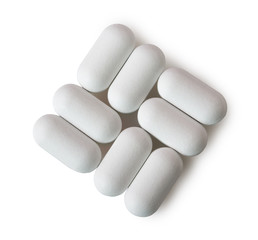 Obraz na płótnie Canvas White oval pills isolated on white