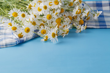 Wildflowers bouquet on blue table at sunset
