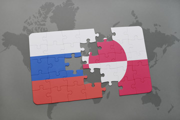 puzzle with the national flag of russia and greenland on a world map background.