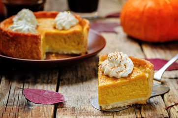 pumpkin pie decorated with whipped cream