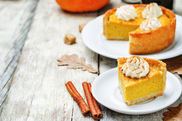 pumpkin pie decorated with whipped cream. toning. selective focus