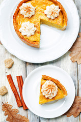 pumpkin pie decorated with whipped cream