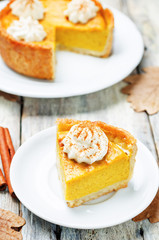 pumpkin pie decorated with whipped cream