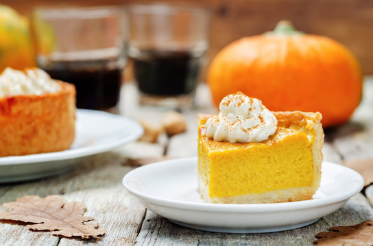 pumpkin pie decorated with whipped cream