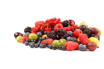 lots of fresh different berries on a white background