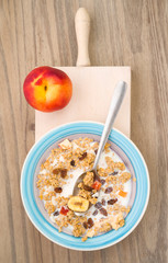 aerial shot of bowl of cereal with fresh peach