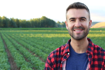 Handsome farmer standing proud and satisfied smiling 