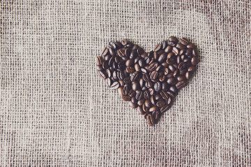 Burlap texture with coffee beans heart shape