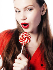 young pretty brunette girl with red candy posing on white background isolated