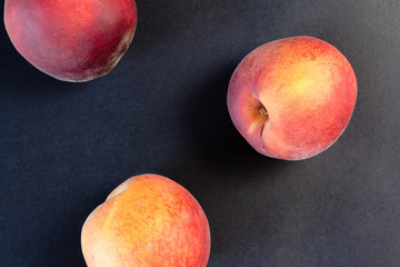 Close up shot of fresh peaches on a black background