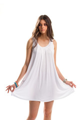 Naklejka premium Girl in short white sarafan. Set of bright-colored bracelets. Simple clothing for warm season. Youth and purity.