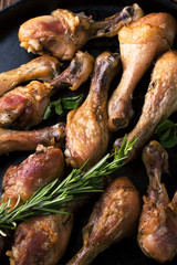 Fried chicken legs with spices, rosemary and mint