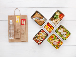 Healthy food take away in boxes, top view at wood