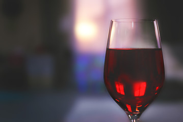 Glass of red wine on blurred background