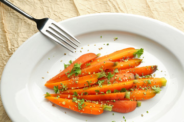Plate of sliced baby carrot with herbs closeup