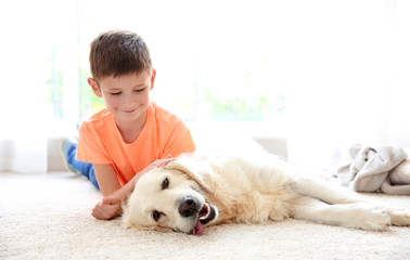 Small boy and cute dog at home