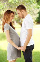 Fototapeta premium Pregnant woman and her husband in park