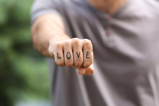 Man fist with fake tattoo