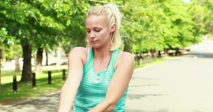 Fit woman stretching in the park