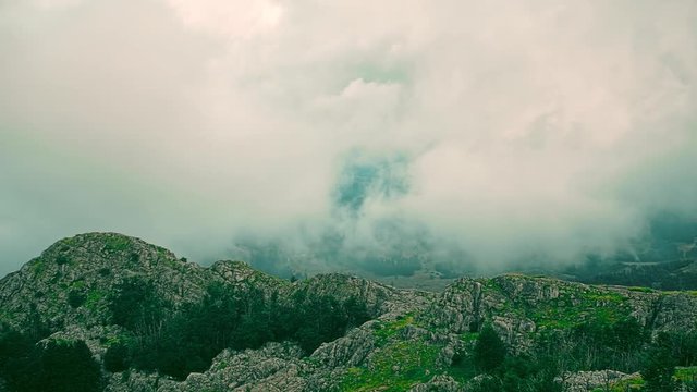 Cloudy weather view of the highest peaks of the Lovcen mountain national park in southwestern Montenegro, paning from the right to the left.