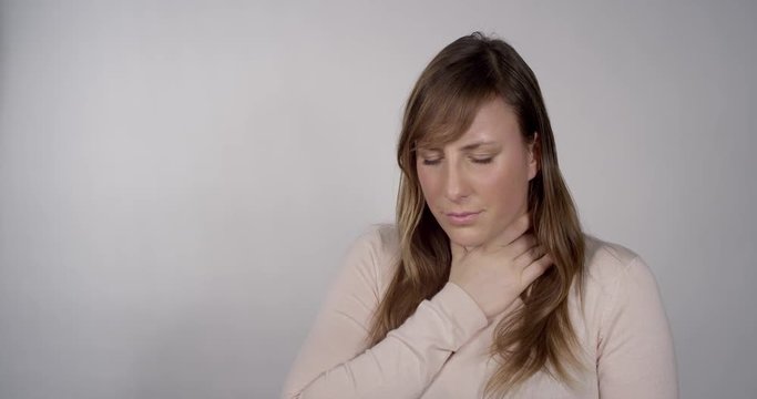 Young woman having a sore throat
