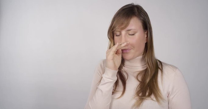 Young woman sneezes