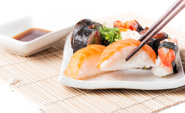 salmon sushi on chopstrick.