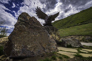 Statue of Eagle near big rock